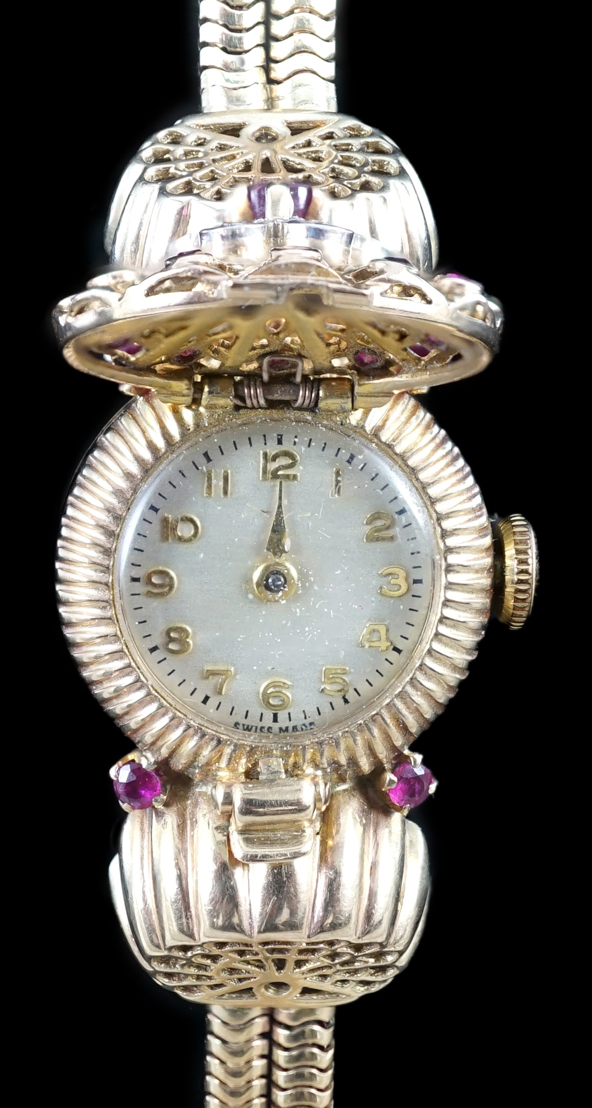 A lady's 1950's 9ct gold, ruby and diamond set manual wind cocktail watch, on a 9ct gold twin strand snake link bracelet